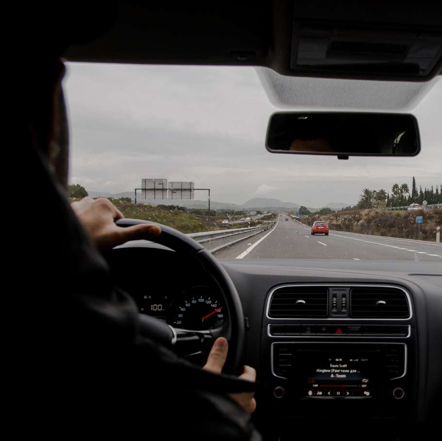 A Person Driving A Car
